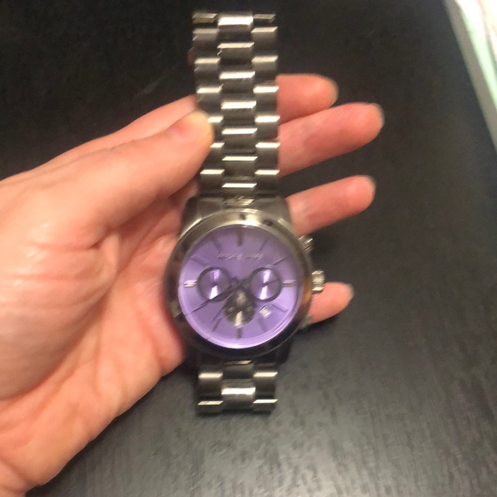 Chrome with purple face MK watch.